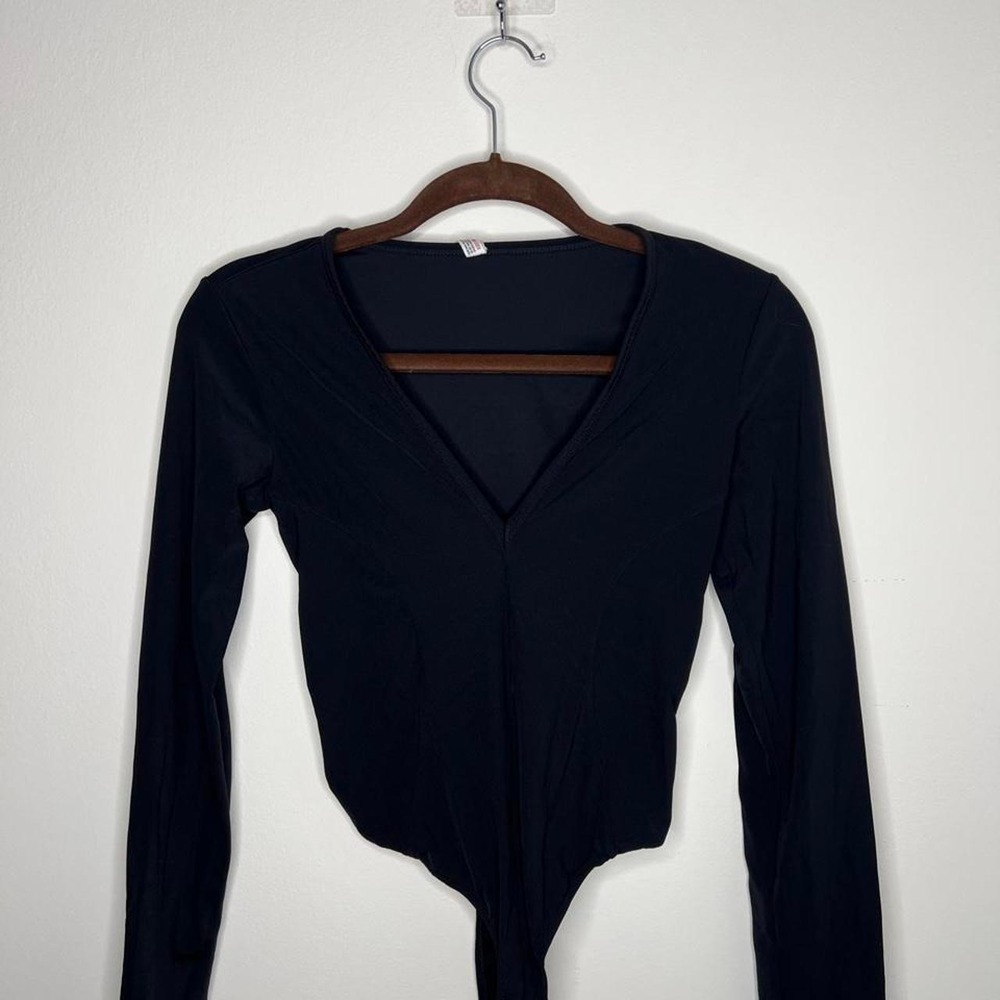 Free People black long sleeve bodysuit with V-neckline and backless design